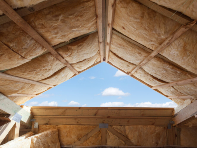 Fibreglass insulation installed in the sloping ceiling of a new frame house. Spray Foam In loft