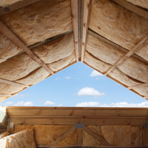 Fibreglass insulation installed in the sloping ceiling of a new frame house. Spray Foam In loft
